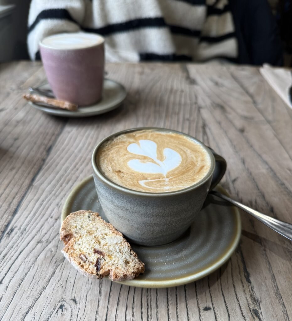 Photo showing two coffee cups on a wooden table